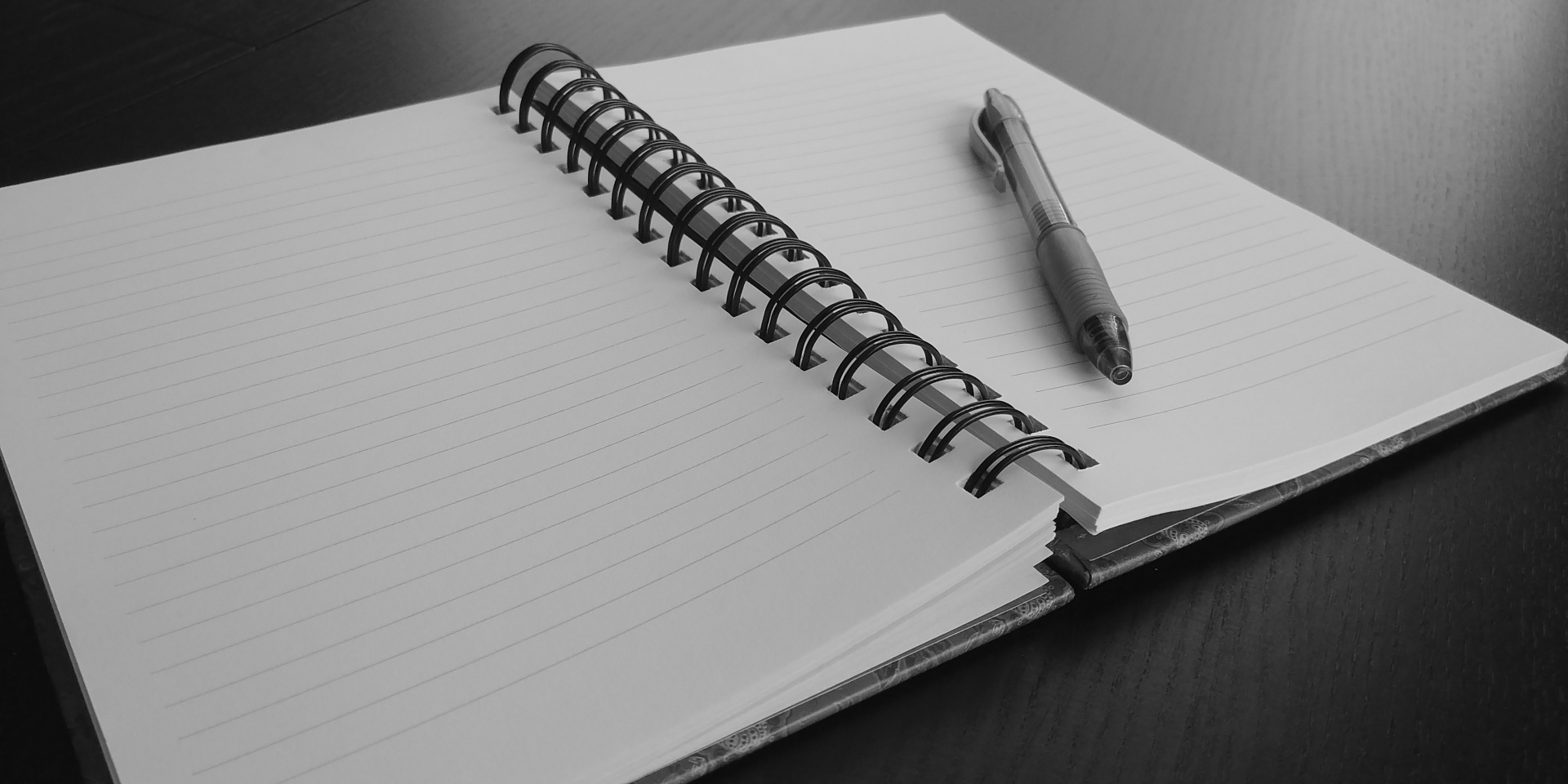 Notebook with a pen on top